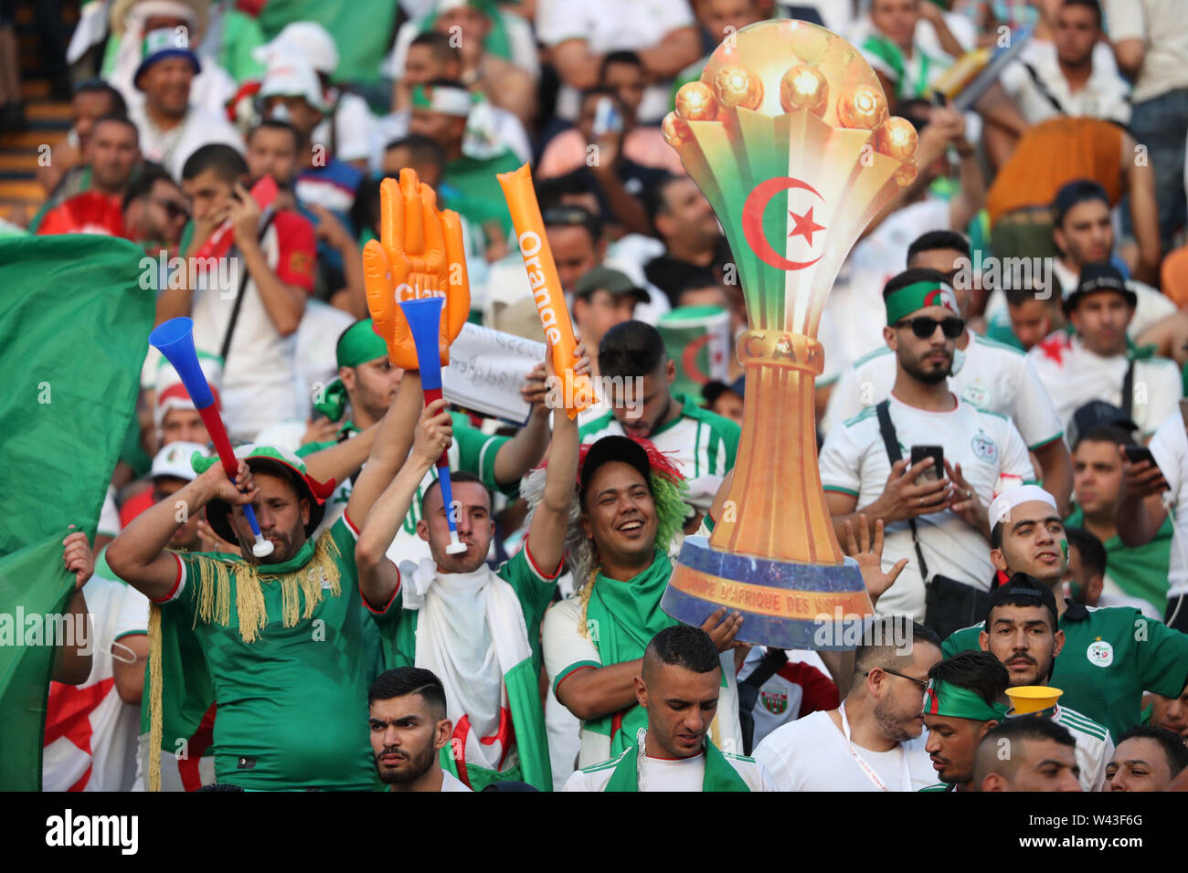 Cairo, Egypt. 19th July, 2019. Algerian fans cheer in the stands prior to the start of the 2019 Africa Cup of Nations final soccer match between Senegal and Algeria at the Cairo International Stadium. Credit: Gehad Hamdy/dpa/Alamy Live News Stock Photo