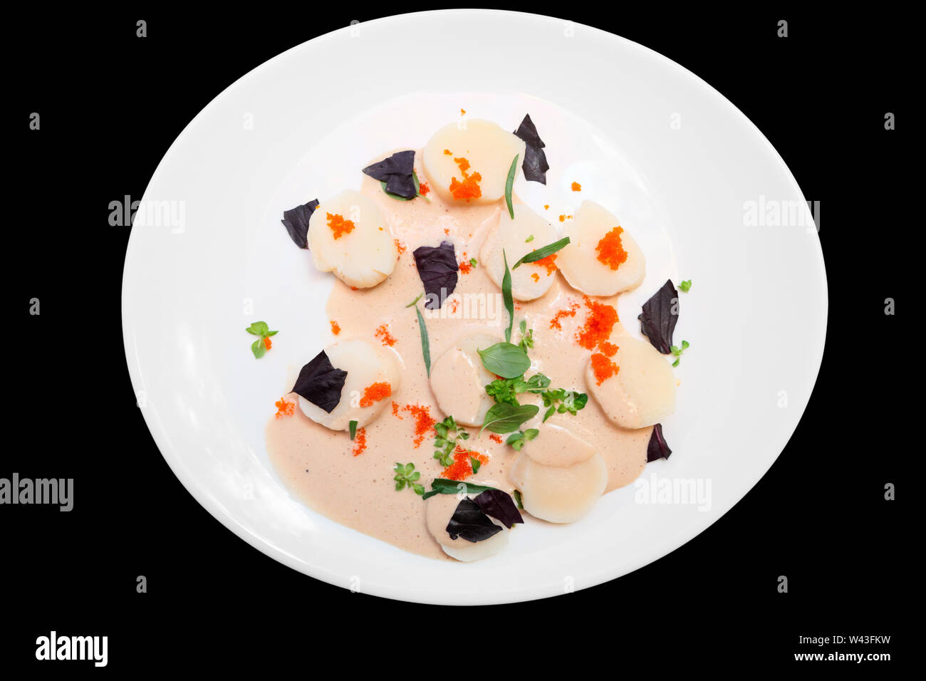 Scallop carpaccio with flying fish roe, meal rich in protein, isolated