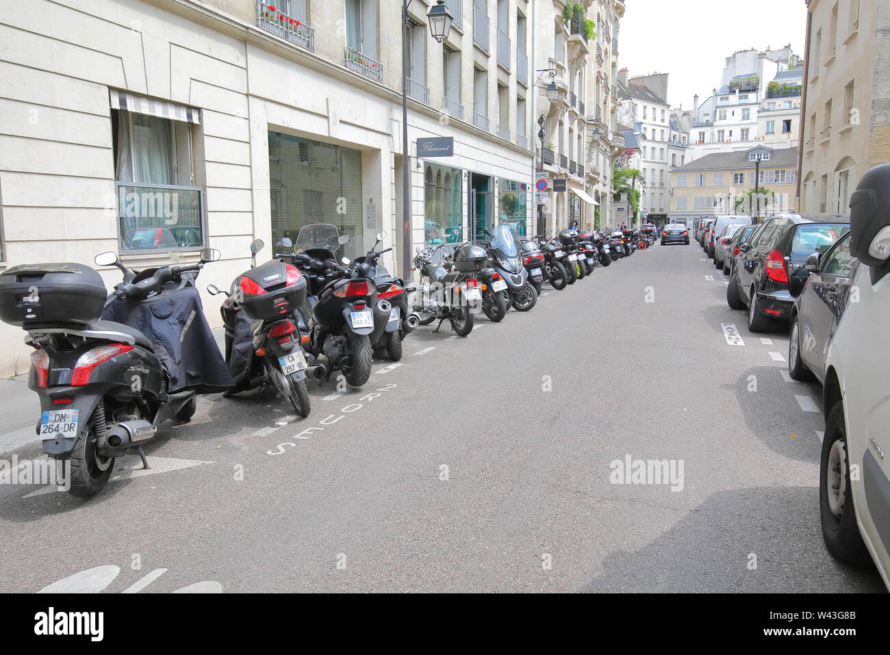 Motorbike and cars parked on street in downtown Paris France Stock Photo -  Alamy