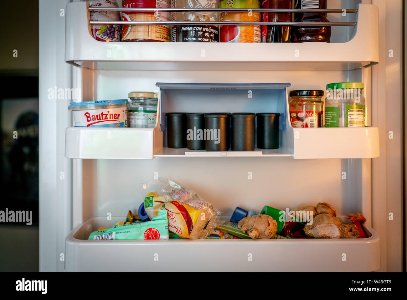 refrigerator filled with food but also analogue film reels Stock Photo