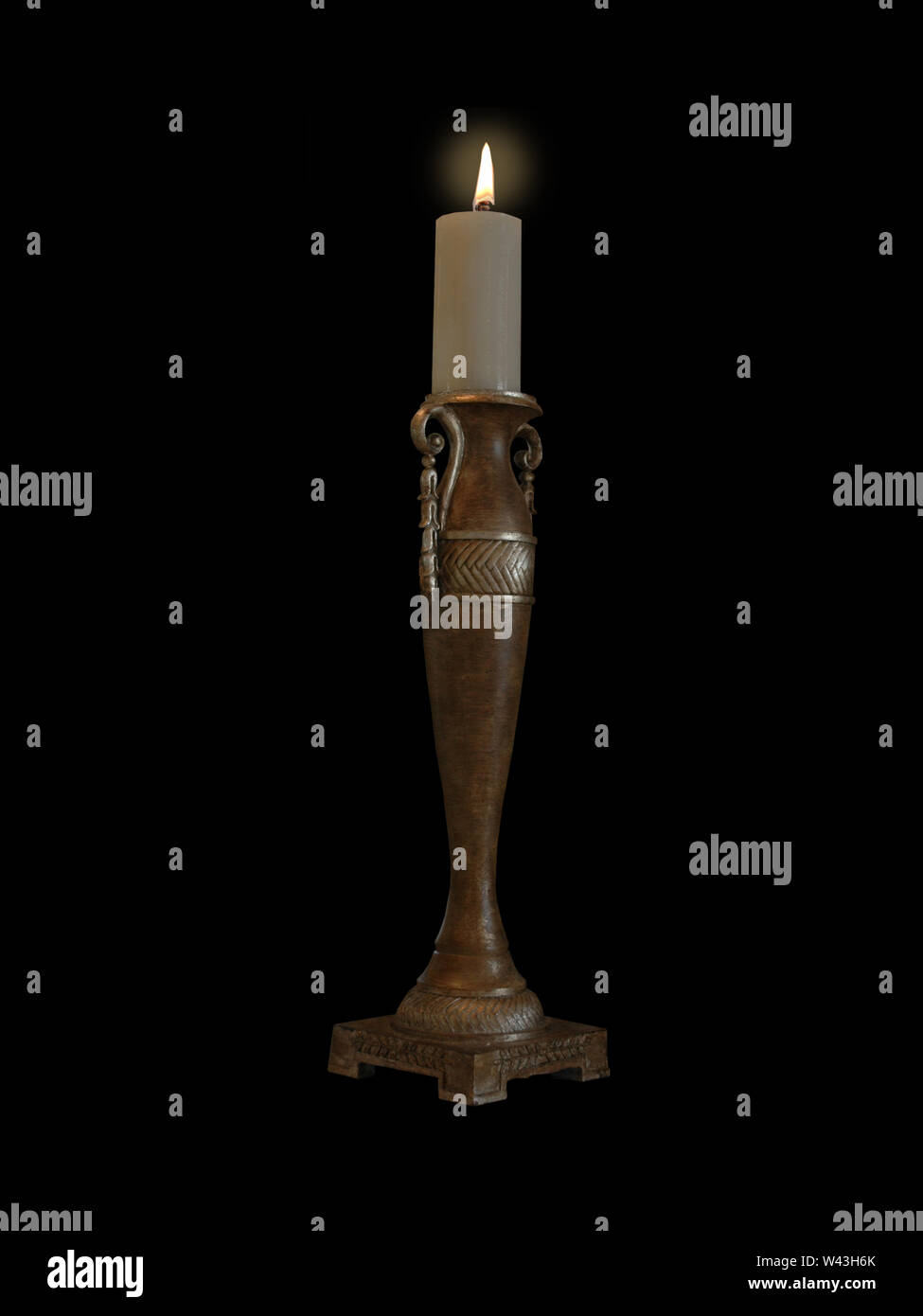 Burning Wax Candle Isolated on Black Background. Stock Photo