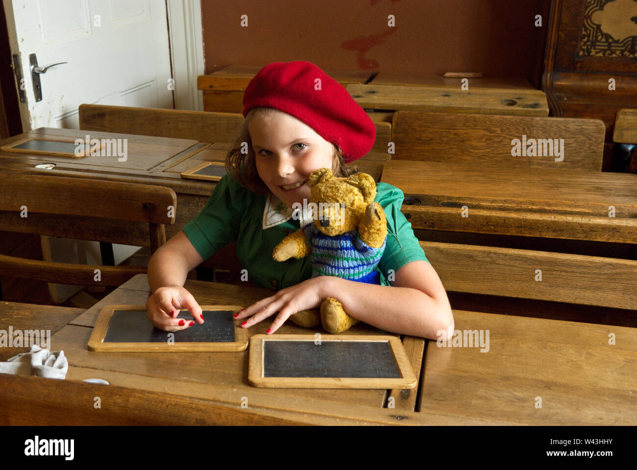 Young Girl In 1940 S Costume With A Stuffed Teddy Bear Sitting