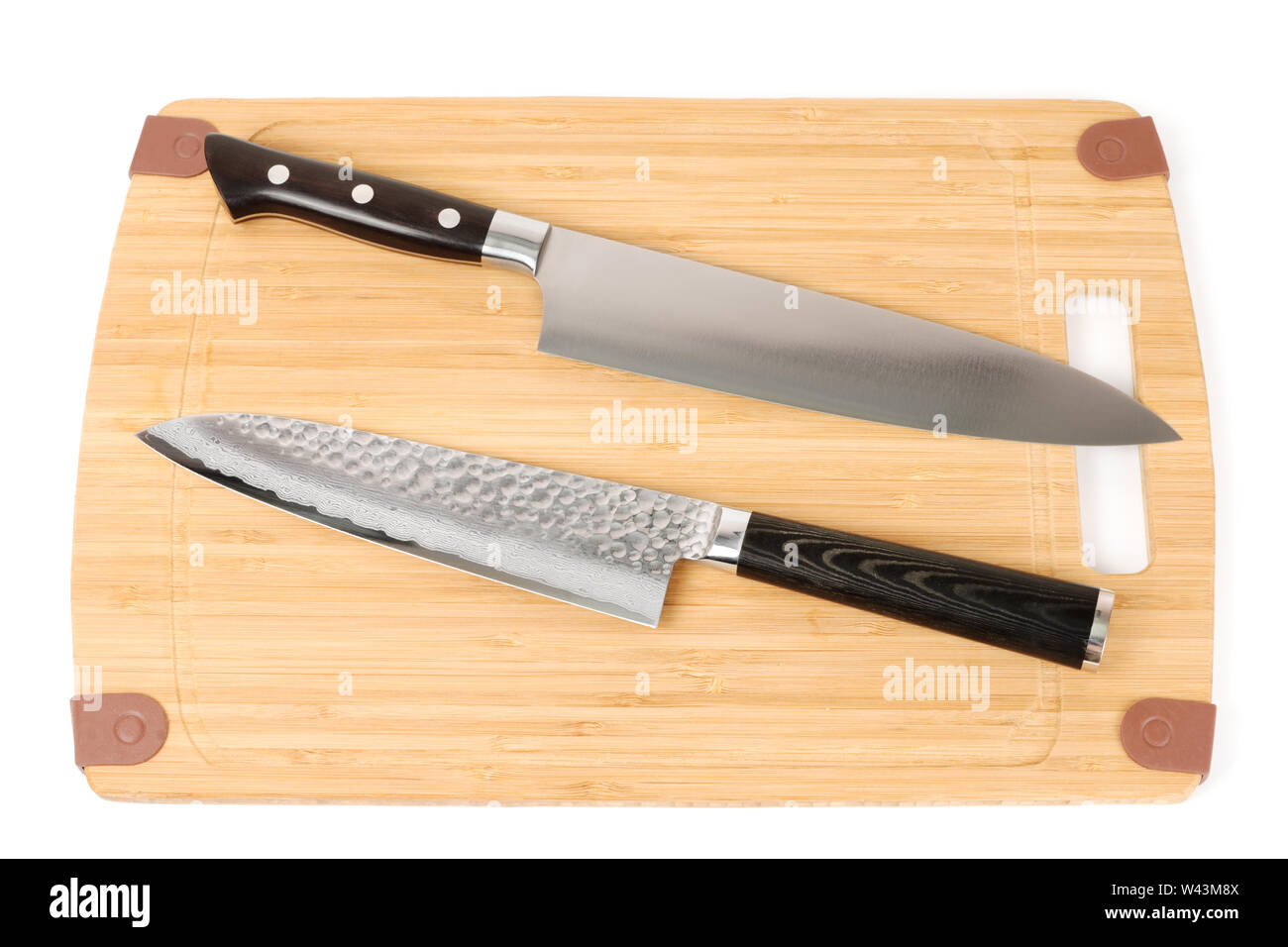 Two knives on a cutting board Stock Photo