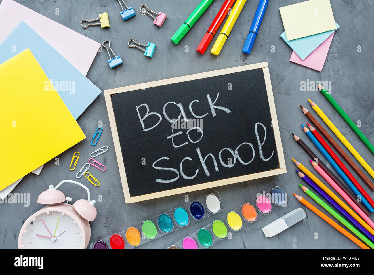 Orange back to school flat lay with bright stationery. School supplies ...
