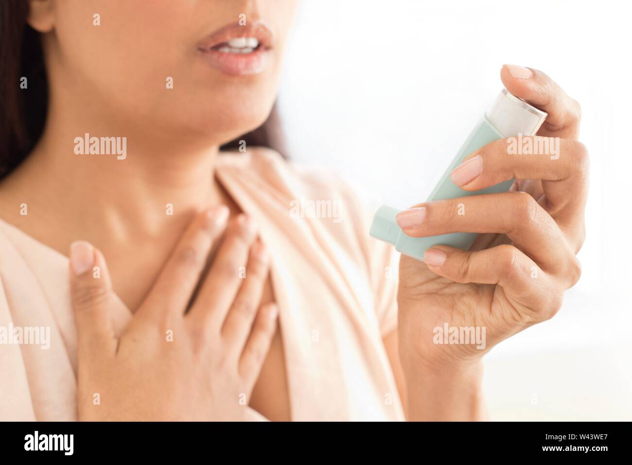 Woman using inhaler. Stock Photo