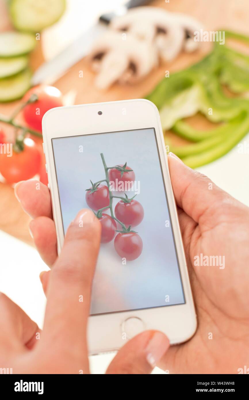 Woman checking calories on smartphone. Stock Photo