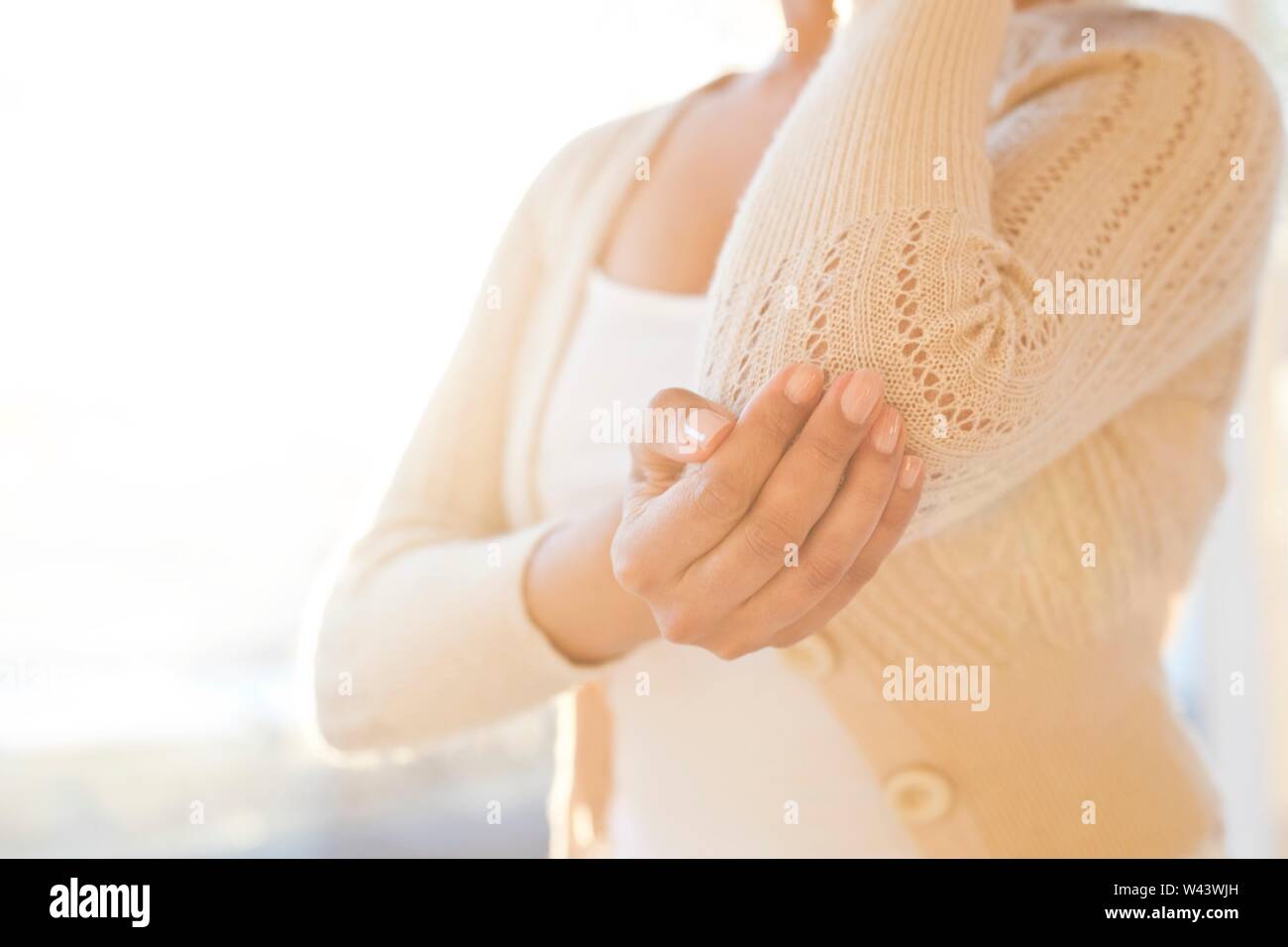 Woman touching sore elbow Stock Photo Alamy