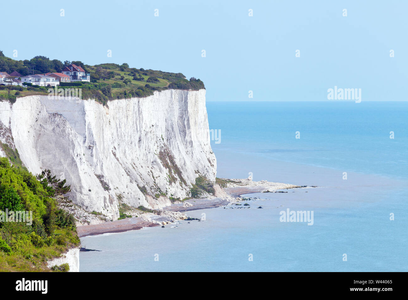Edge of white cliffs of Dover, English Channel blue waters on a sunny summer day . Stock Photo