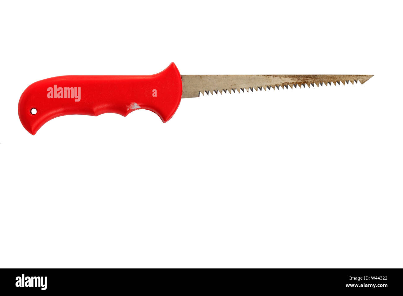 Manual narrow old saw for wood and pruning with a sharp end and a red plastic handle isolated on a white background. Stock Photo