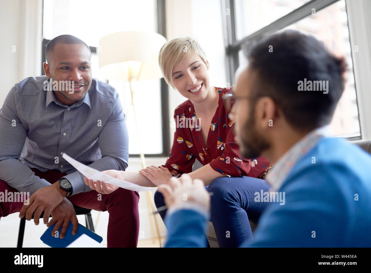 Multi-ethnic team of creative millenials collaborating on a brainstorm project Stock Photo