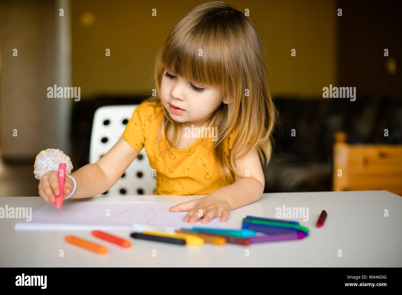 nice little girl drawing with wax pastel Stock Photo - Alamy