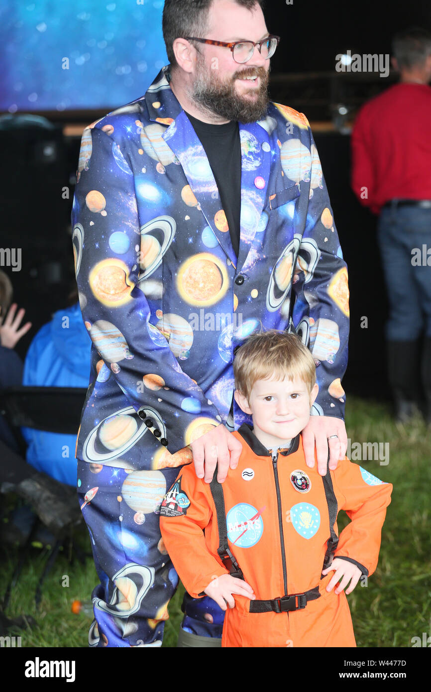 Macclesfield, UK, 19th July, 2019. A child and father dressed for celebrating fifty years since the Moon landings at the Bluedot festival with four days of speakers, music and science with the Lovell telescope as a backdrop, Jodrell Bank, Macclesfield, Cheshire, UK. Credit: Barbara Cook/Alamy Live News Stock Photo