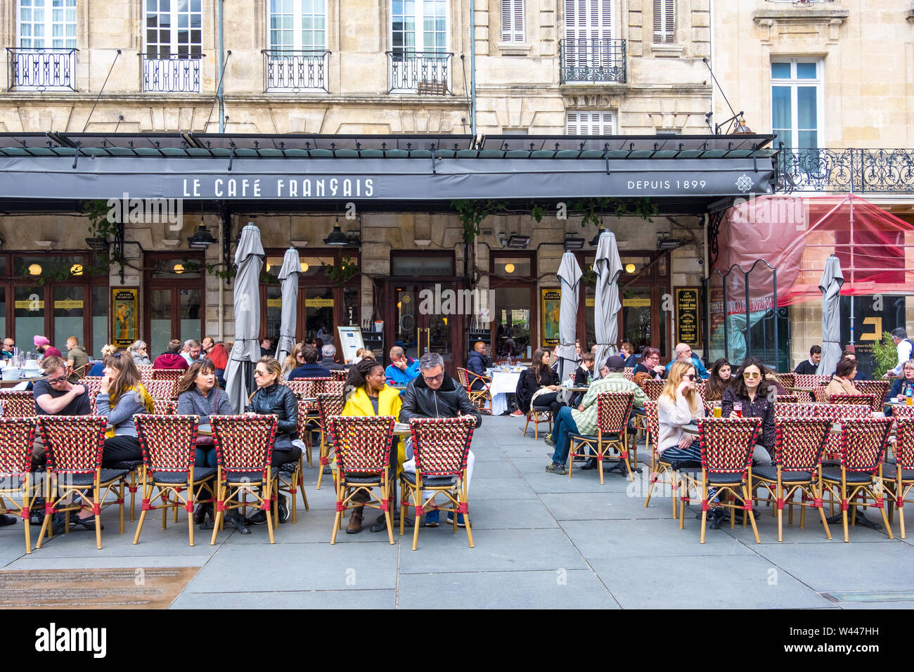 Bordeaux, France - May 5, 2019: A people relax in Cafe Francais on Place Pey Berland in Bordeaux, Aquitaine, France Stock Photo