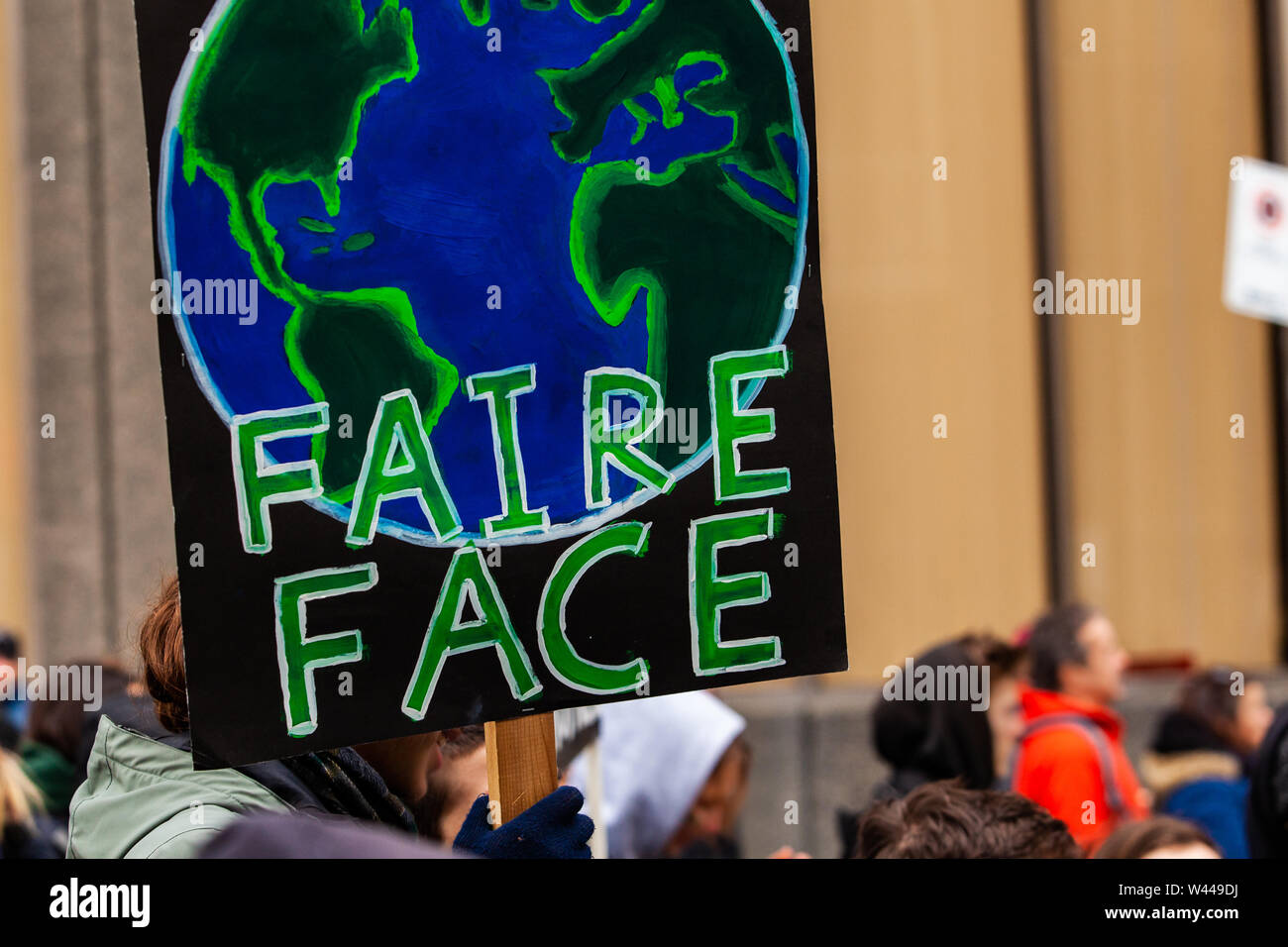 A closeup view of a French sign saying stand up held by an ...