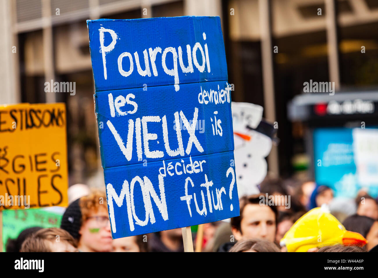 A close up view of a French placard reading why should old people decide my future as environmentalists march on a street in Montreal, Canada Stock Photo