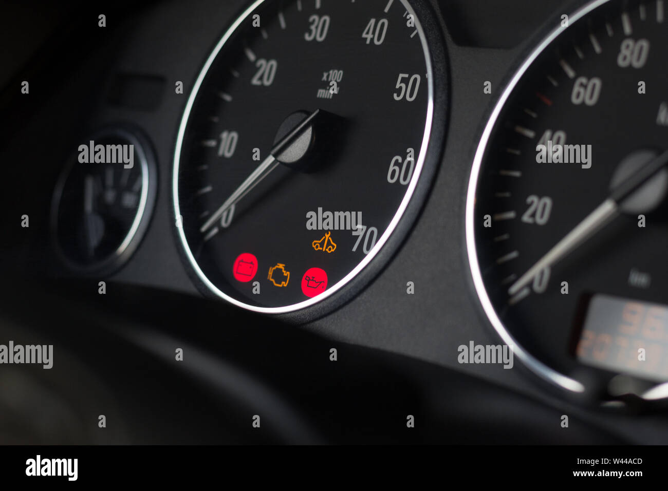 Dashboard indicators of usual car. Selective focus on tachometer