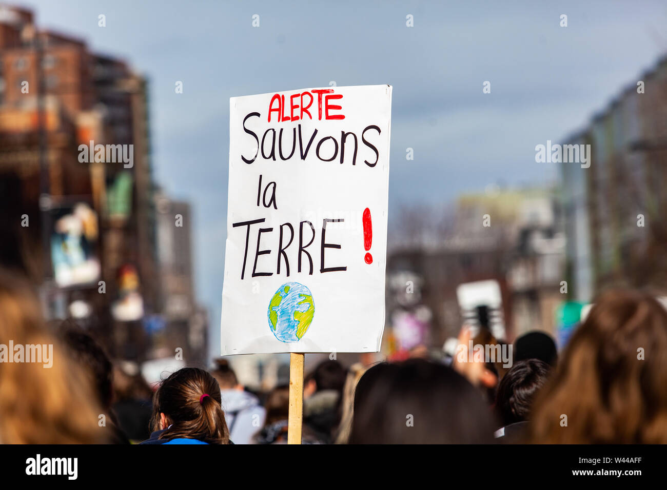 A French sign is viewed close-up above the heads of environmental  demonstrators, saying Alert, save the earth during a gathering in a city  center Stock Photo - Alamy