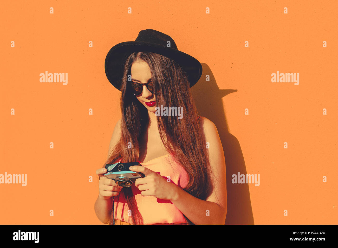 Young girl standing outdoor in front a colorful wall Stock Photo - Alamy