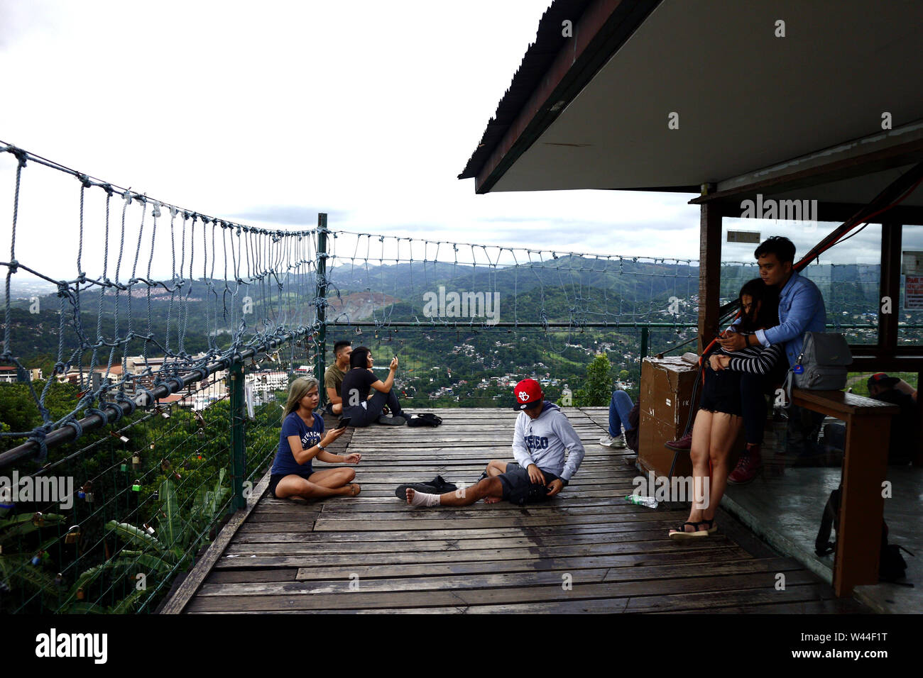 ANTIPOLO CITY, PHILIPPINES – JULY 17, 2019: Visitors and tourists enjoy the view and cool breeze at the top of the 360 degree viewing deck of a restau Stock Photo
