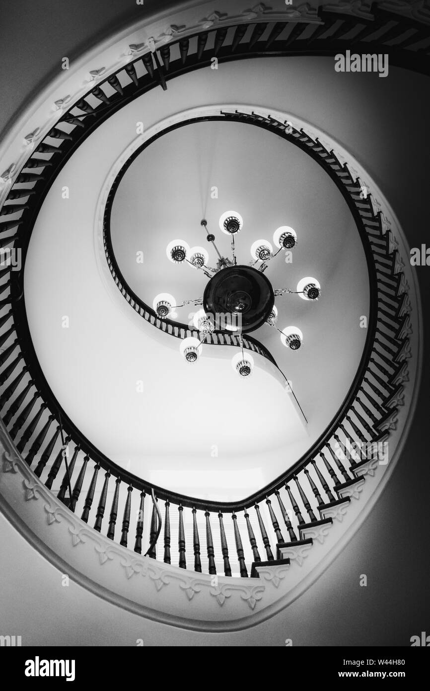 View of a Beautiful cantilevered spiral staircase with a chandlier inside the historic Alabama State Capitol building in Montgomery, AL, USA, in black Stock Photo