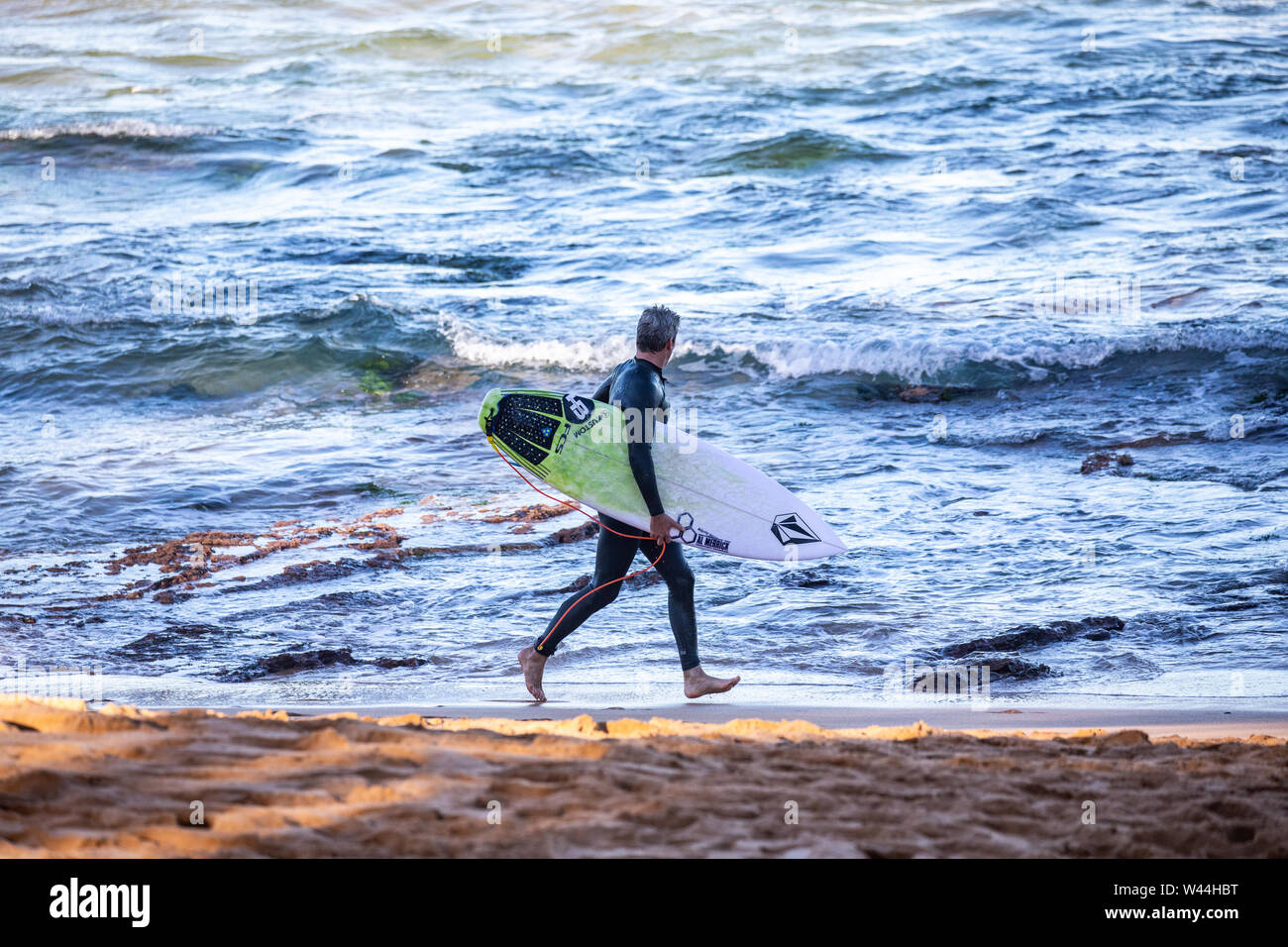 Australian surfers at Avalon beach in Sydney surfing the waves Stock Photo