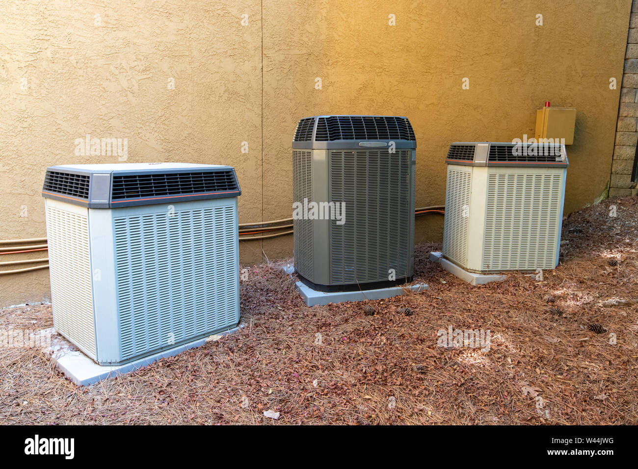 Multiple Air Conditioner Compressors next to large house or building