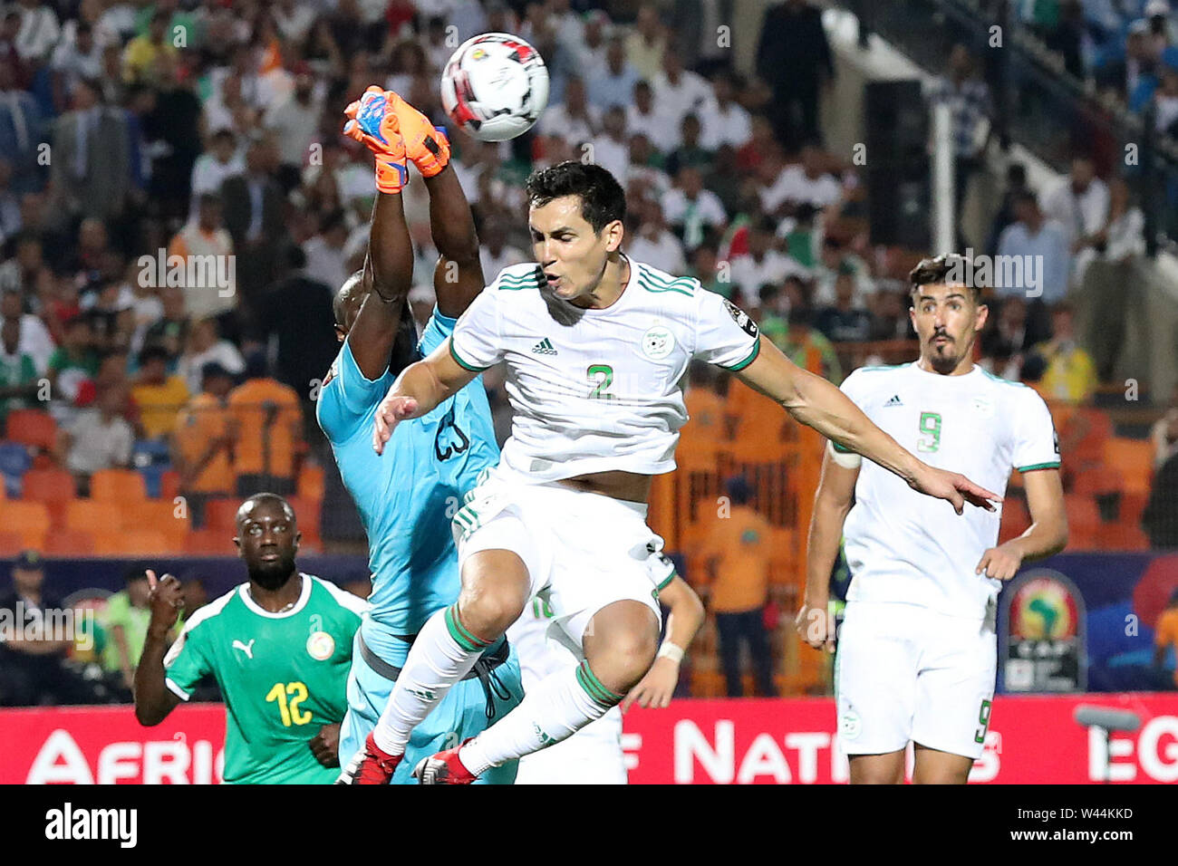 Cairo, Senegal vies with Aissa Mandi (2nd R) of Algeria during the 2019 Africa Cup of Nations final match between Senegal and Algeria in Cairo. 19th July, 2019. Amigo Alfred Junior Gomis (L), goalkeeper of Senegal vies with Aissa Mandi (2nd R) of Algeria during the 2019 Africa Cup of Nations final match between Senegal and Algeria in Cairo, Egypt on July 19, 2019. Algeria won 1-0 and claimed the title. Credit: Wang Teng/Xinhua/Alamy Live News Stock Photo