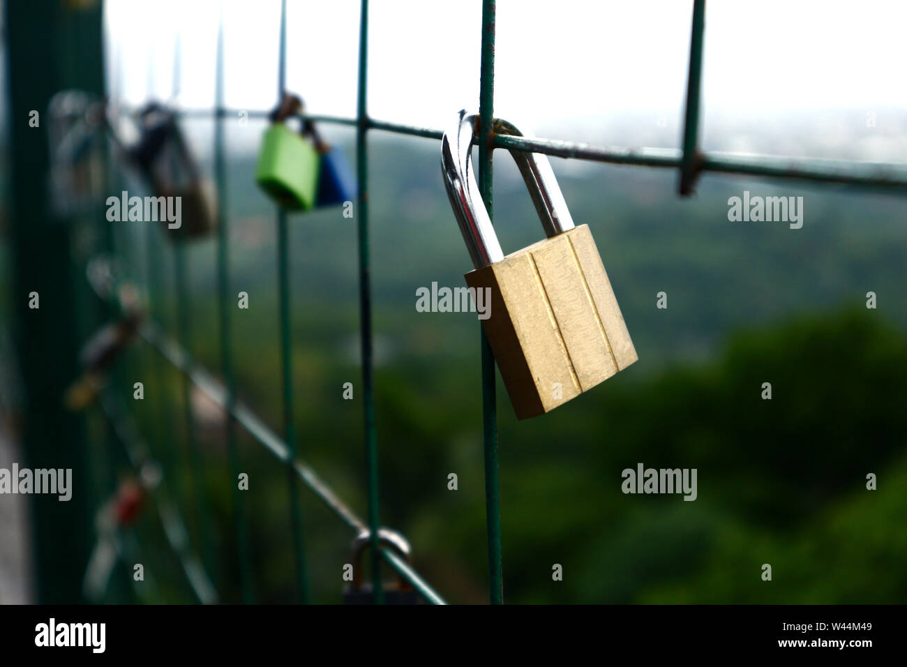Close up photo shot of padlocks on a wire fence as a symbol of promise