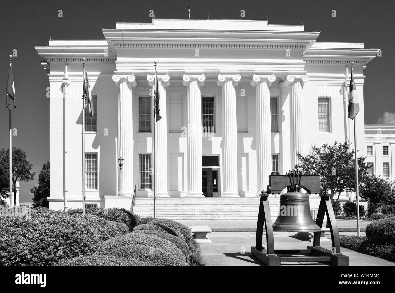 A replica of the Liberty Bell in front of the Historic Alabama State Capitol's Southeast entrance in Montgomery, AL, in black and white Stock Photo