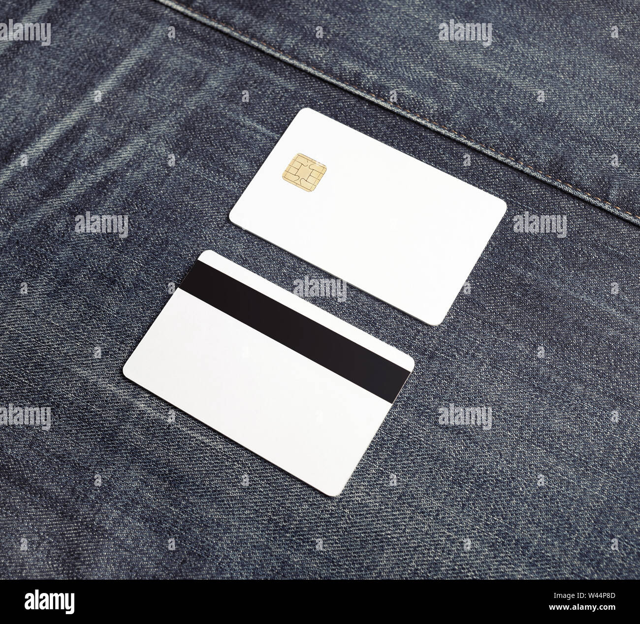 Two blank credit cards on gray denim background. Bank cards. Front and back view. Stock Photo