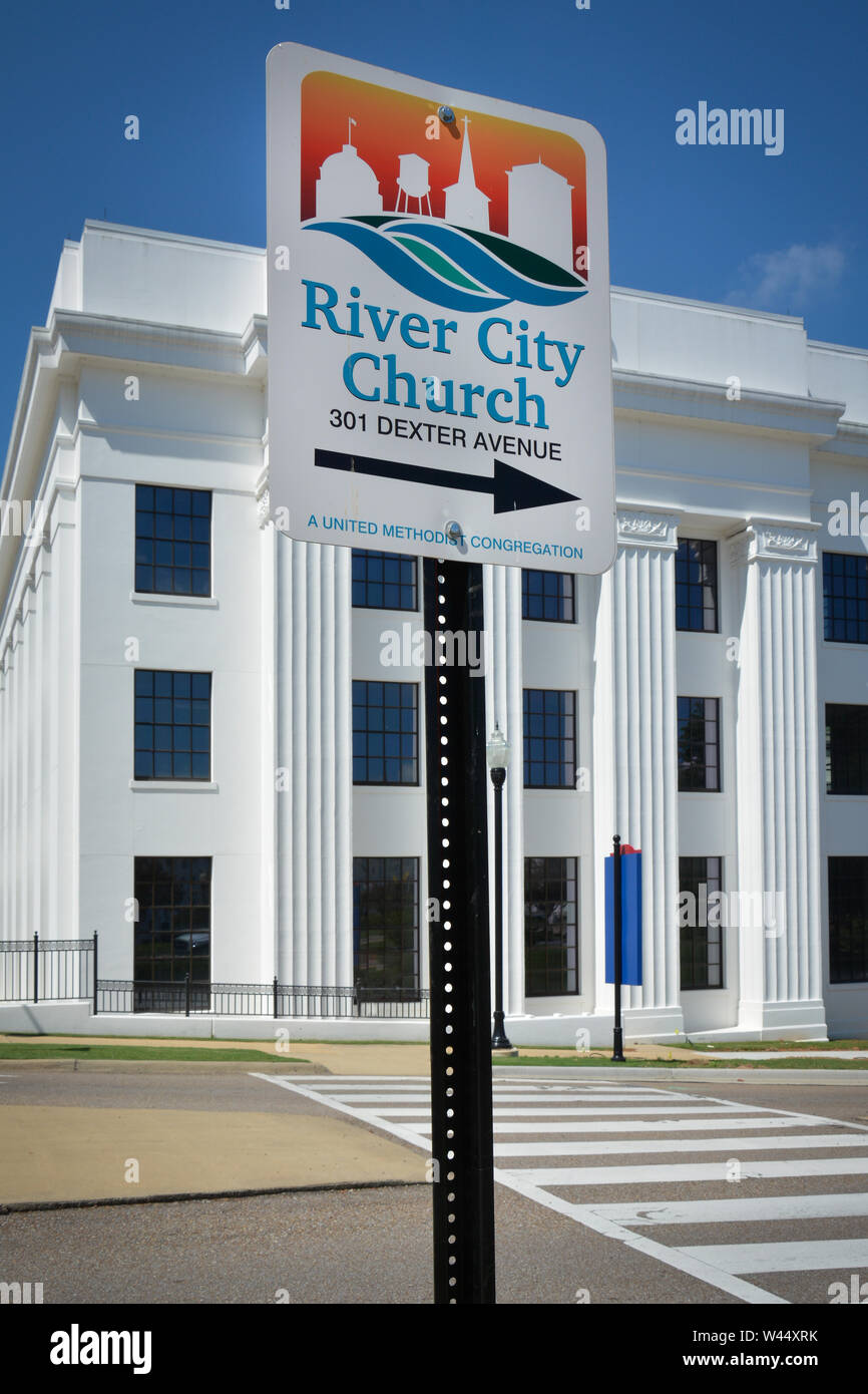 An illustrated street sign with directional arrow to the River City Church against a white government building in downtown Montgomery, AL, USA Stock Photo