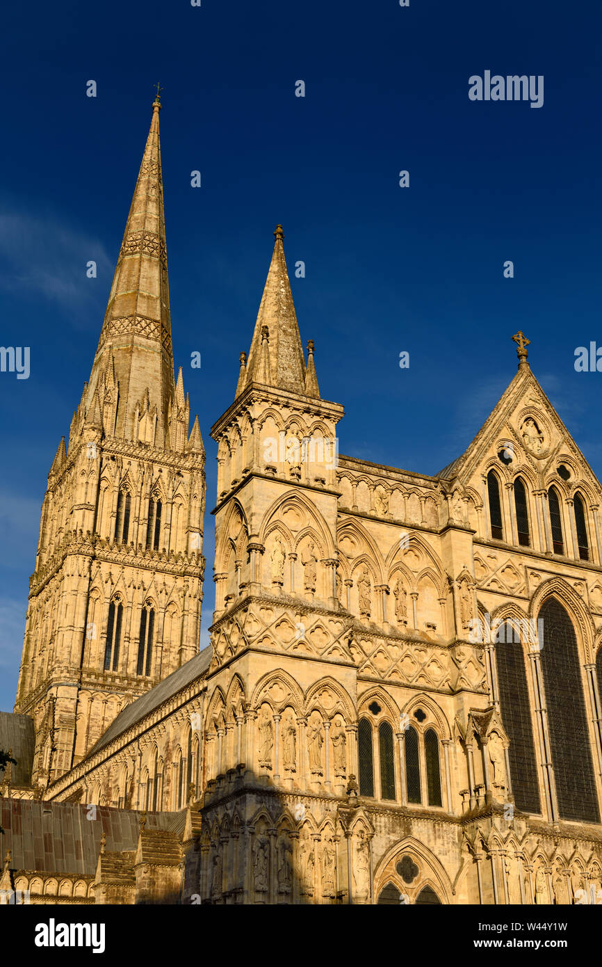 Great West Front facade of Salisbury Cathedral with Spire in late evening light in Salisbury England Stock Photo