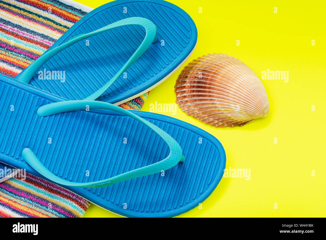 Folded Colorful Striped Organic Cotton Beach Towels, Blue Flip Flops ...