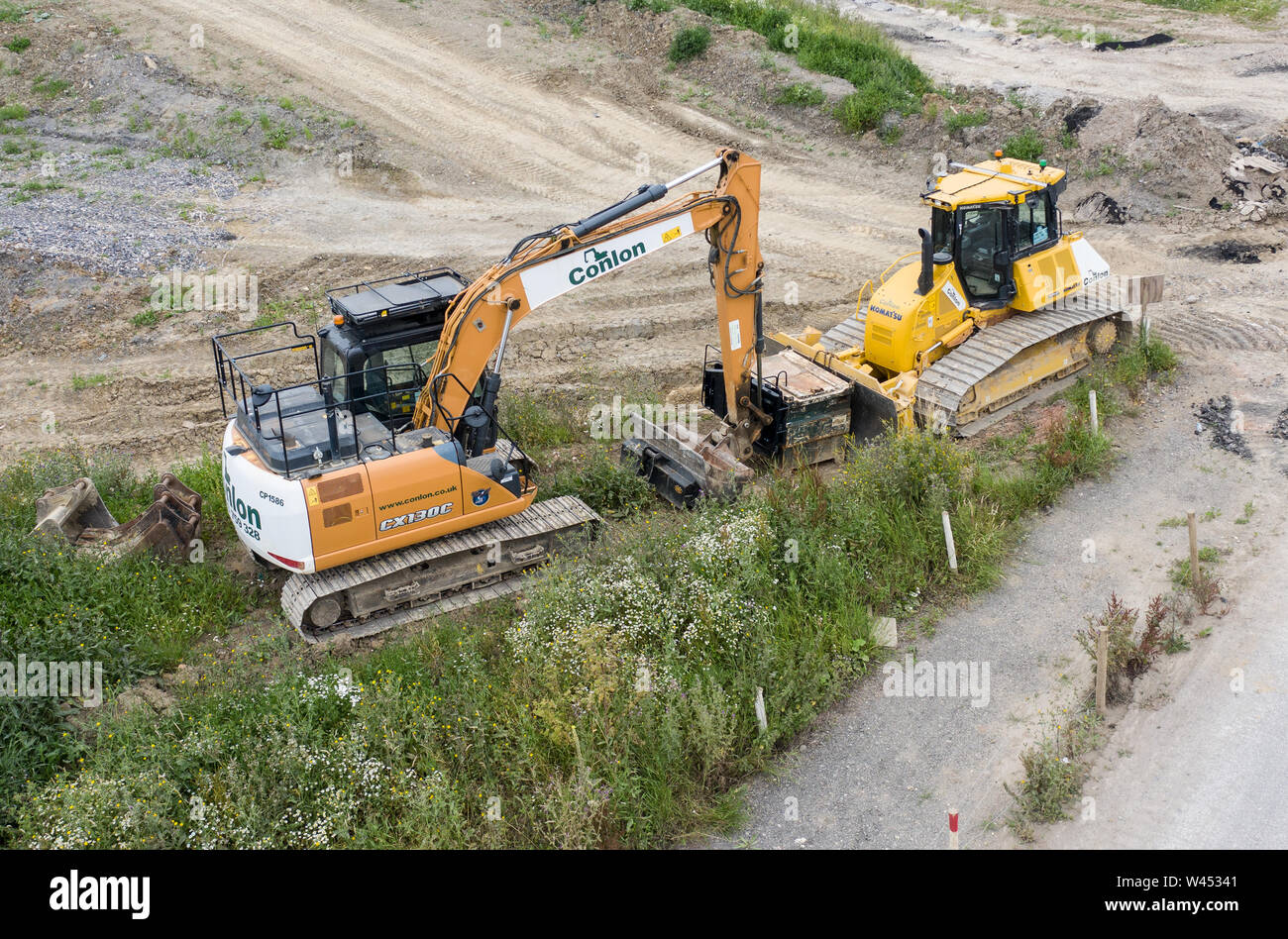 SWINDON, UK - JULY 16, 2019:  Case CX13C Crawler Excavator and Komatsu Bulldozer on a construction site close to the new Deanery School and Waitrose i Stock Photo
