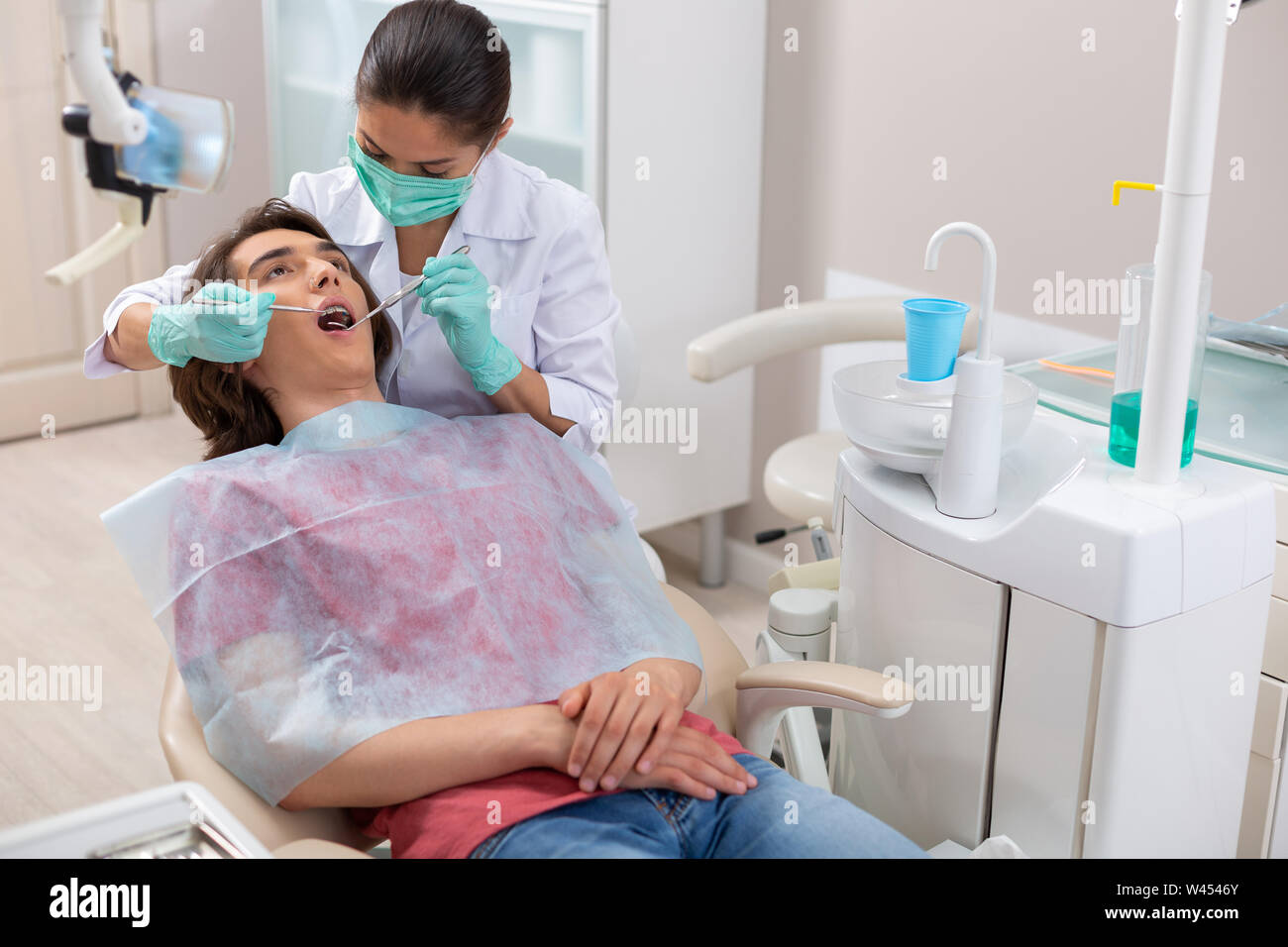 Dentist putting the dental braces on her patients teeth Stock Photo Alamy
