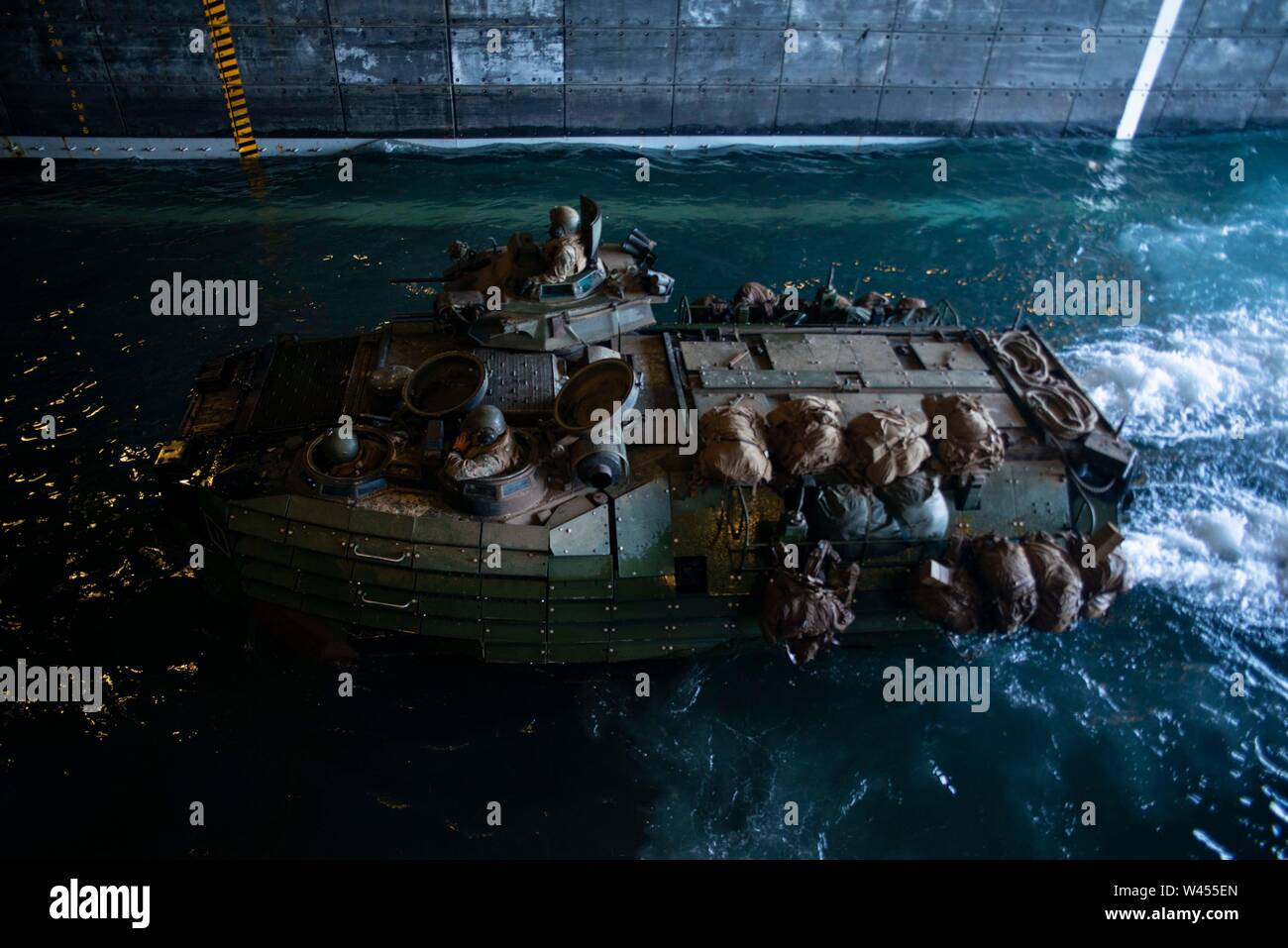 190718-N-DX072-1214 STANAGE BAY, Australia (July 18, 2019) An assault amphibious vehicle (AAV), assigned to the 31st Marine Expeditionary Unit (MEU), transits through the well deck of the amphibious transport dock ship USS Green Bay (LPD 20). Green Bay, part of the Wasp Expeditionary Strike Group, with embarked 31st MEU, is currently participating in Talisman Sabre 2019 off the coast of Northern Australia. A bilateral, biennial event, Talisman Sabre is designed to improve U.S. and Australian combat training, readiness and interoperability through realistic, relevant training necessary to maint Stock Photo