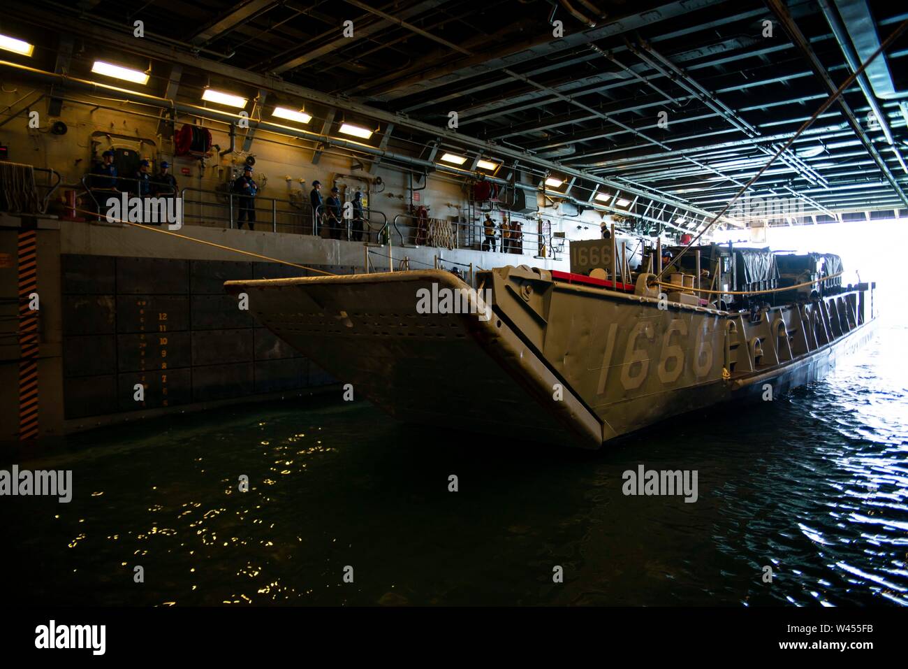 190719-N-DX072-1004 STANAGE BAY, Australia (July 19, 2019) Landing Craft, Utility (LCU) 1666 prepares to depart the well deck of the amphibious transport dock ship USS Green Bay (LPD 20). Green Bay, part of the Wasp Expeditionary Strike Group, with embarked 31st Marine Expeditionary Unit, is currently participating in Talisman Sabre 2019 off the coast of Northern Australia. A bilateral, biennial event, Talisman Sabre is designed to improve U.S. and Australian combat training, readiness and interoperability through realistic, relevant training necessary to maintain regional security, peace and Stock Photo