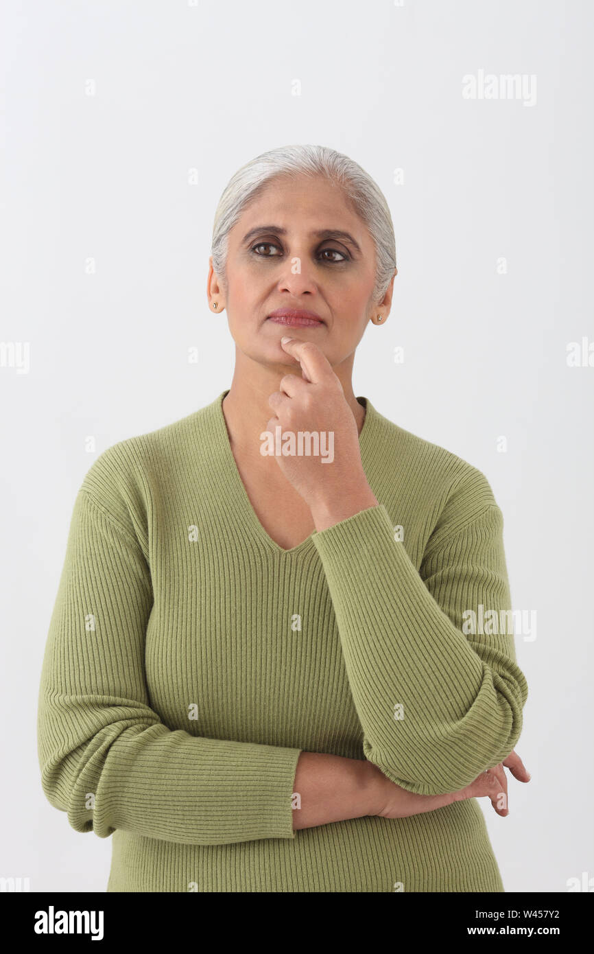 Old woman thinking chin on hands hi-res stock photography and images ...