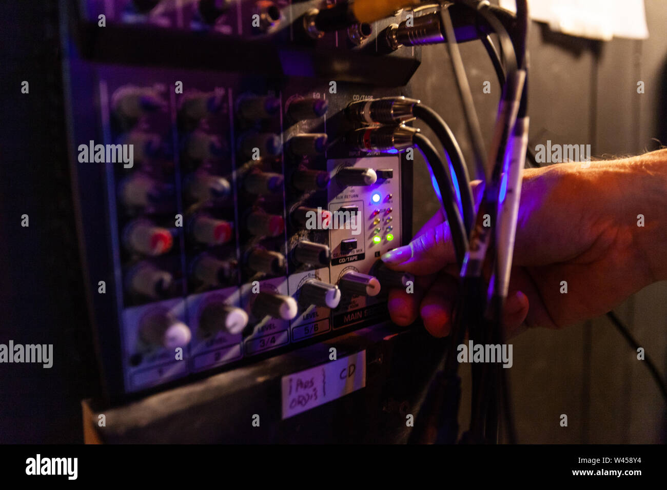 A close up view on the hand of a music producer using audio equipment