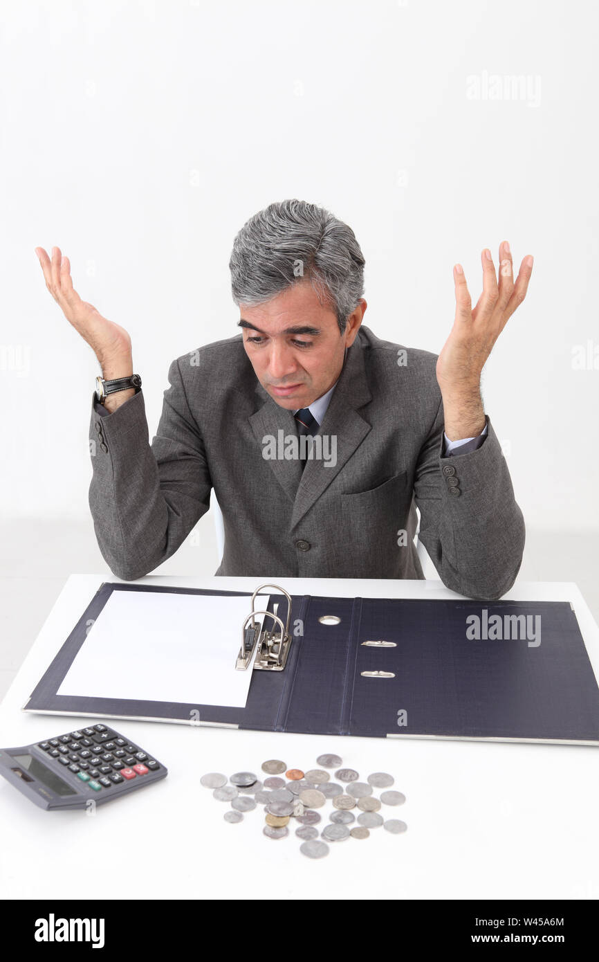 Depressed businessman working out finances Stock Photo