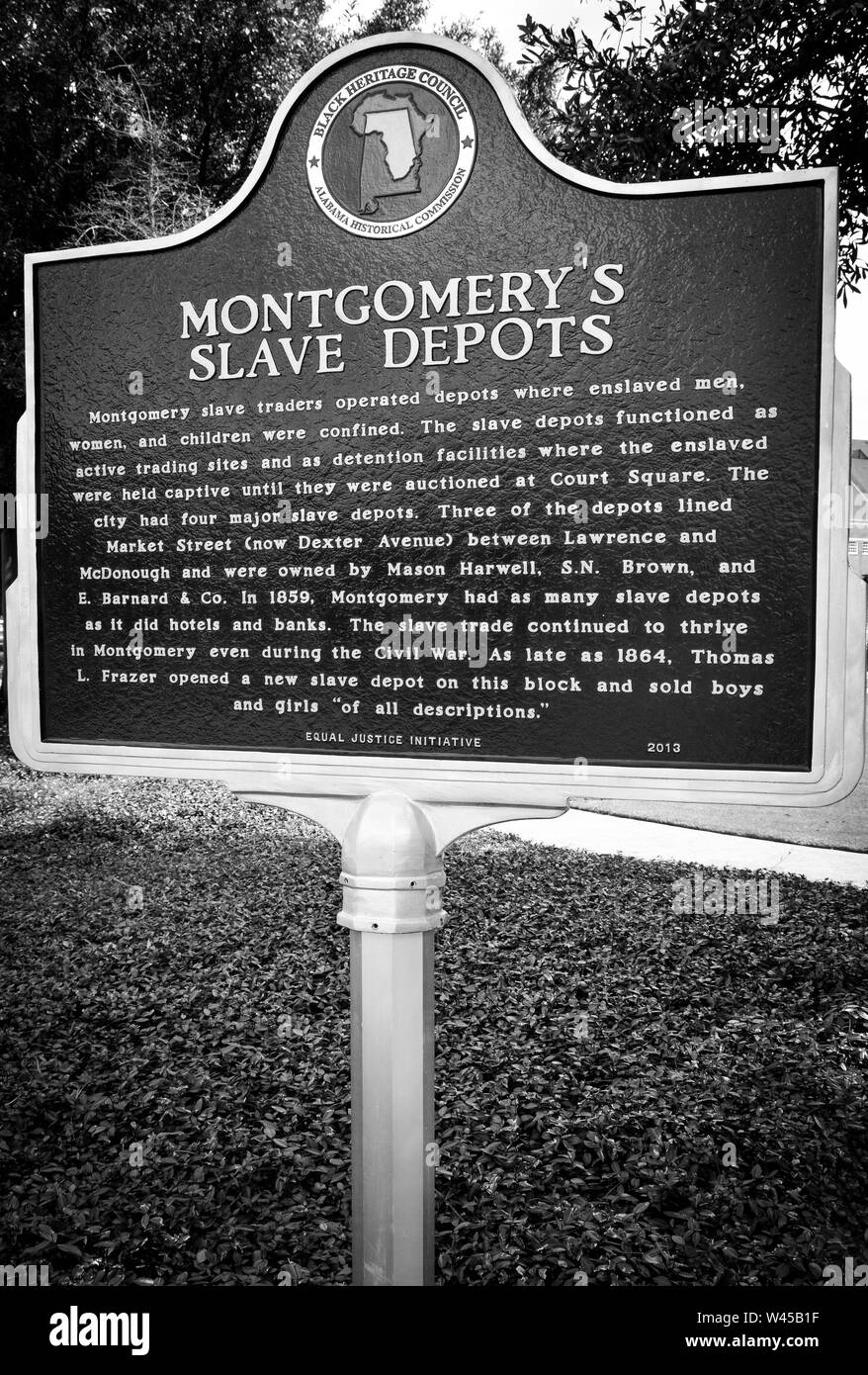 A historical marker notes the site of depots used for confinement of slaves until they were auctioned off at the nearby Square in Montgomery, AL, USA Stock Photo