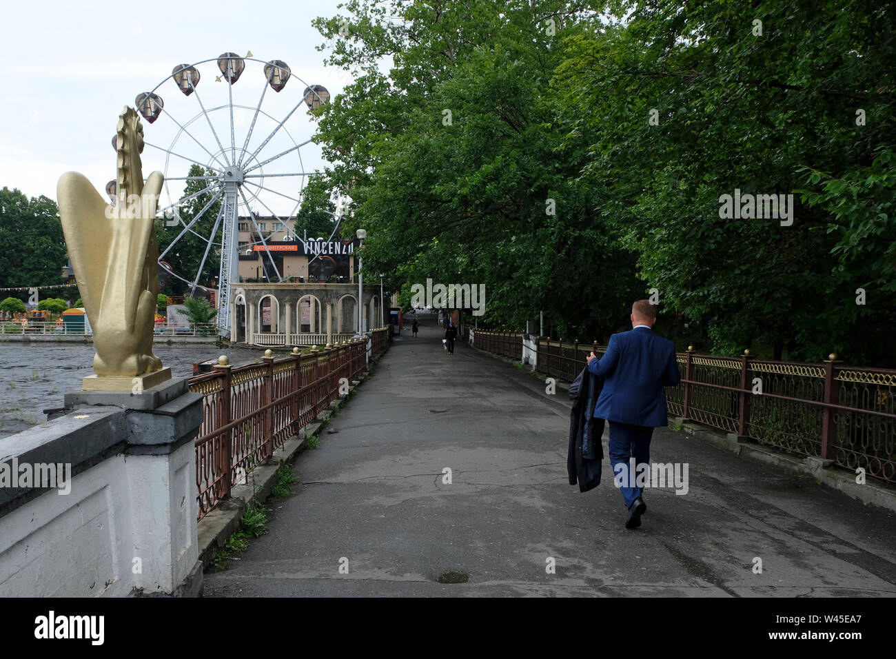 Pedestrians crossing Peshekhodnyy Most Grifonom bridge over Terek river in Vladikavkaz the capital city of the Republic of North Ossetia-Alania in the North Caucasian Federal District of Russia. Stock Photo