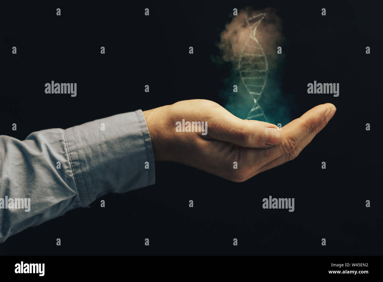 Man holding DNA molecule in palm Stock Photo - Alamy