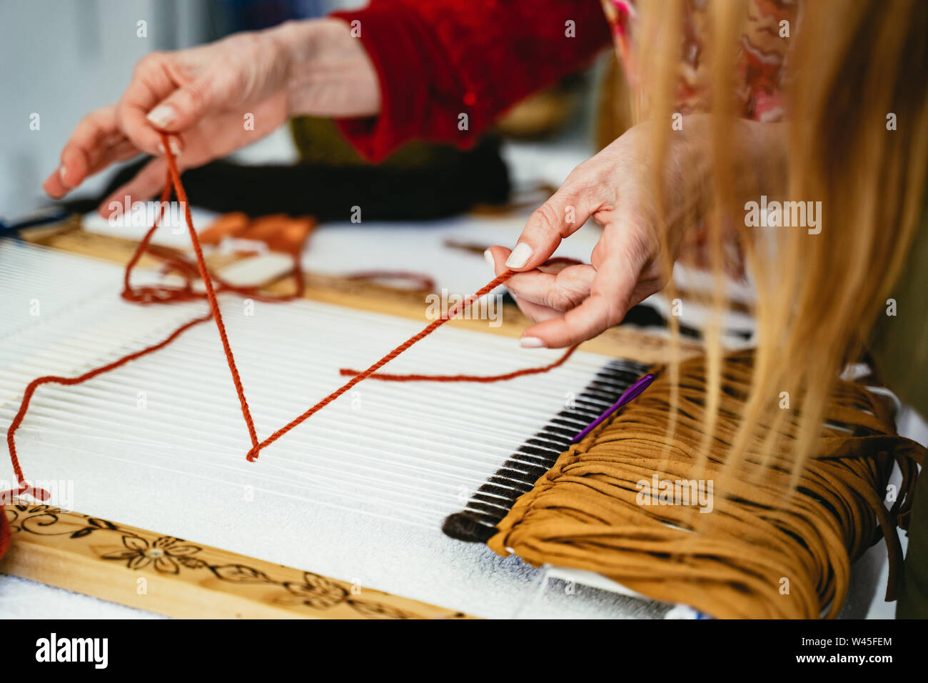 Woman demonstrating weaving and knotting Stock Photo Alamy