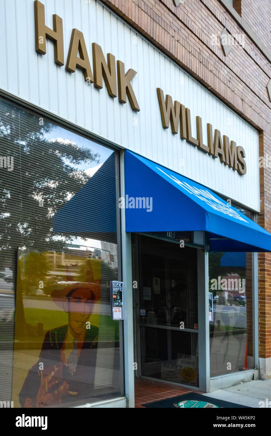 Overhead sign and blue awning at entrance to historic old building now