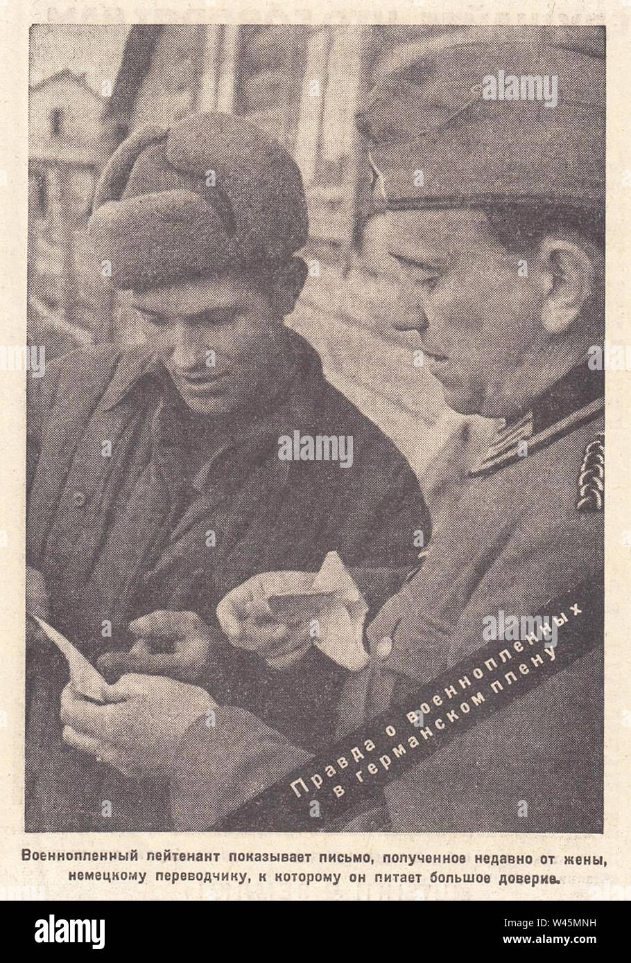 Prisoner of war lieutenant shows a letter received recently from his wife. The truth about prisoners of war in German captivity. Photo from the newspaper of the 1940s. Stock Photo