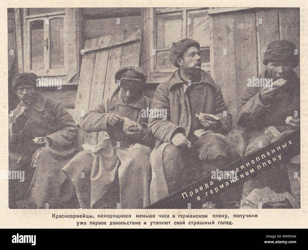 The Red Army soldiers, who were under German imprisonment for less than an hour, had already received their first allowance and satisfied their terrible hunger. The truth about prisoners of war in German captivity. Photo from the newspaper of the 1940s. Stock Photo