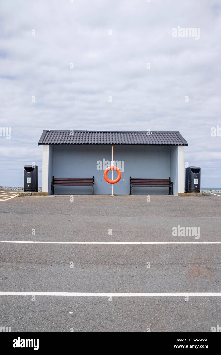 A rather dull weather shelter at a seaside resort overlooking a carpark, Britain, UK Stock Photo