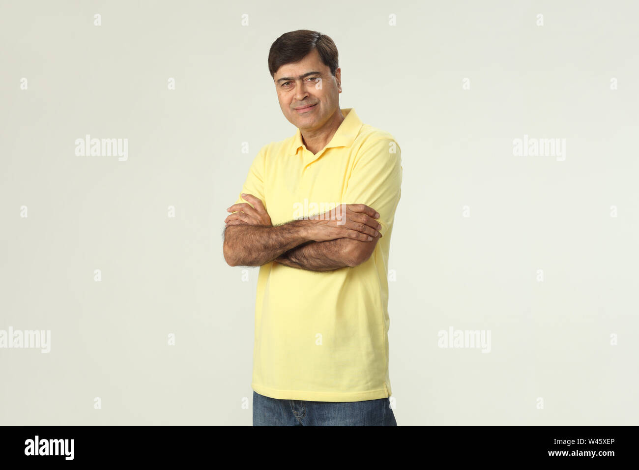 Portrait of a man smiling with his arms crossed Stock Photo - Alamy