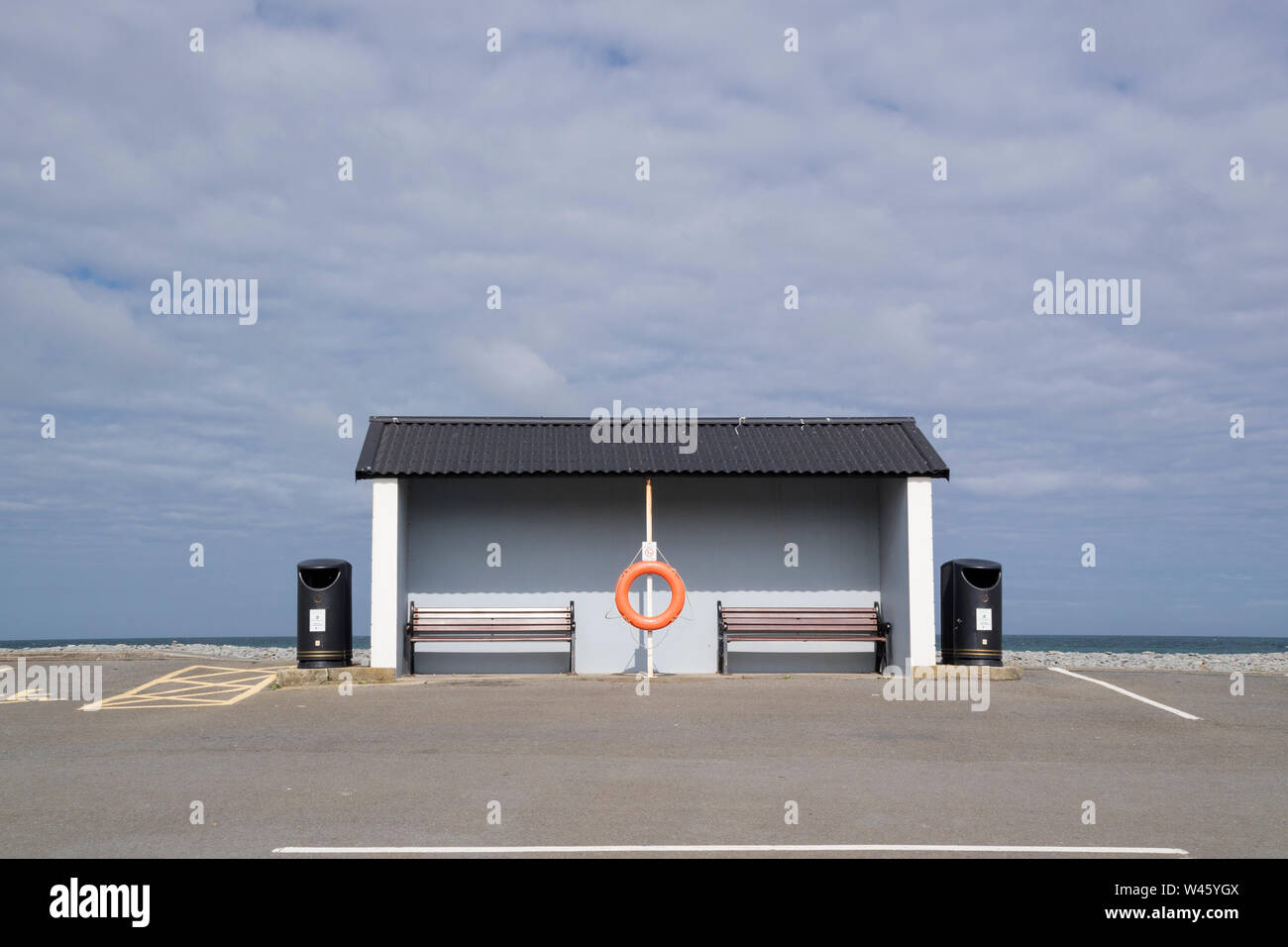 A rather dull weather shelter at a seaside resort overlooking a carpark, Britain, UK Stock Photo